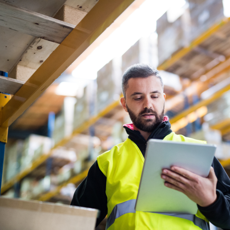 warehouse-worker-looking-at-ipad